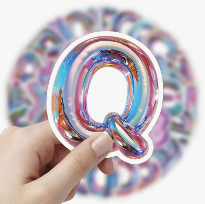 Set of iridescent holographic stickers showing the alphabet A–Z and numbers 0–9 in fun, rounded lettering on a white background.