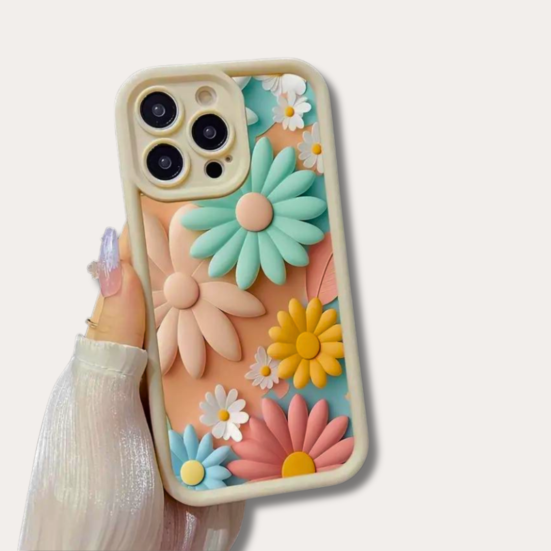 Hand holding an iPhone with a soft silicone case featuring a colourful printed floral design that creates a 3D illusion of raised pastel daisies.